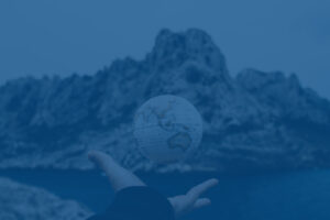 A hand under a levitating small globe.